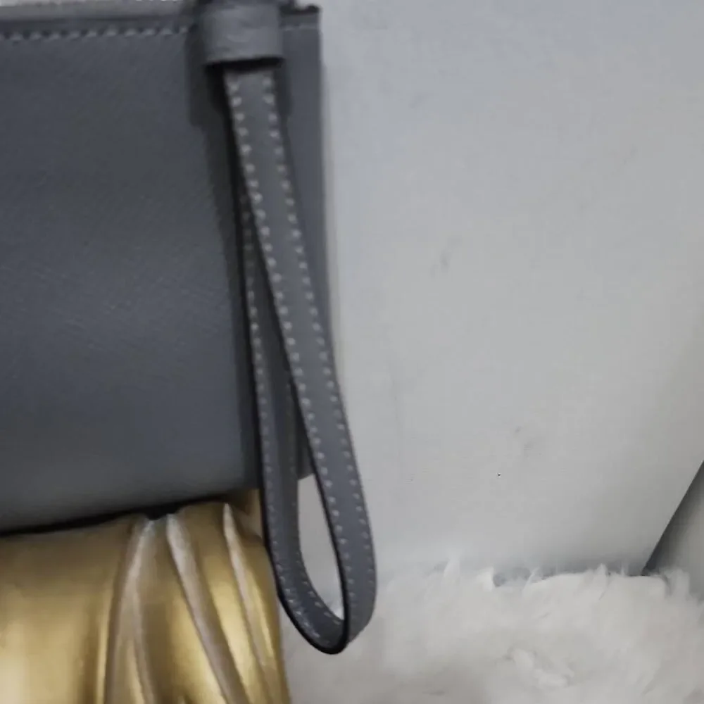Coach Corner Zip Wristlet in a grey crossgrain leather.